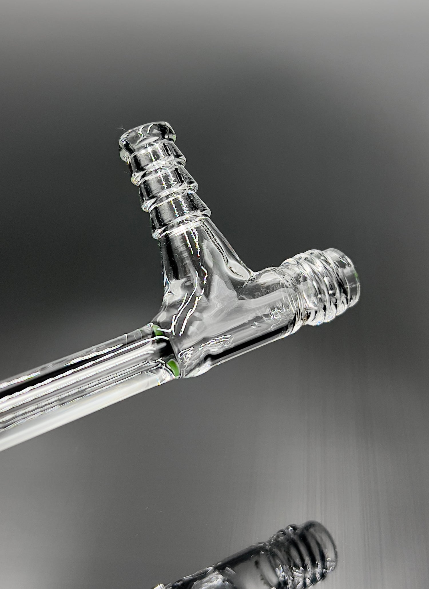 Close-up of a clear glass Fluid vessel with a Gl-14 thread Made in USA